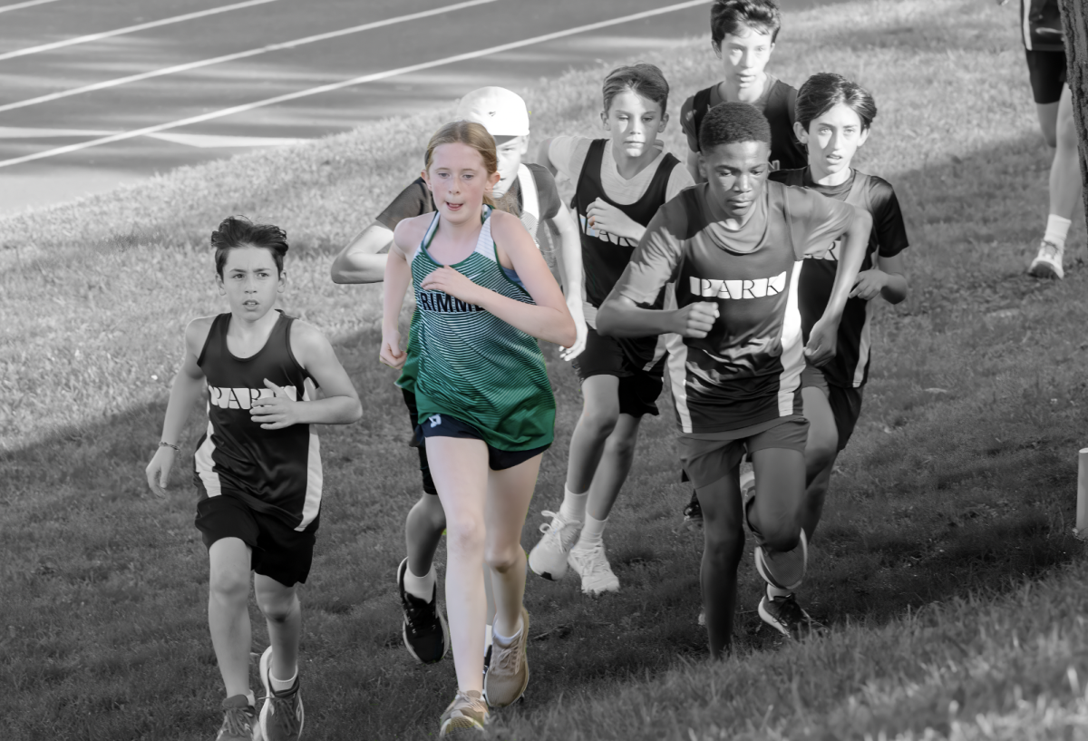 Charlotte Woolley '30 leads a pack of runners at last year's Middle School Cross Country Championship. 